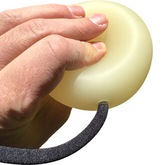 Main tenant une bola contact lumineuse, de forme ronde et translucide, avec un cordon noir.