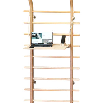 Échelle de gym en bois avec un bureau intégré, sur lequel repose un ordinateur portable affichant une page web, un support pour téléphone et une lampe.