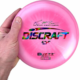 The Paul McBeth ESP Buzzz: an essential mid-range disc for disc golf enthusiasts, offering a predictable trajectory and excellent compatibility.
