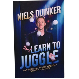 Livre intitulé Learn to Juggle avec l'auteur Niels Duinker, présentant une couverture dynamique. L'image montre un jongleur souriant dans un costume noir, tenant des balles blanches, sur un fond bleu et flou évoquant une ambiance de spectacle.