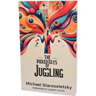 Livre The Paradoxes of Juggling avec une illustration colorée sur la couverture, représentant un jongleur stylisé en position de jonglage, entouré de motifs abstraits et de sphères colorées. Le titre est en lettres noires et le nom de l'auteur, Michael St