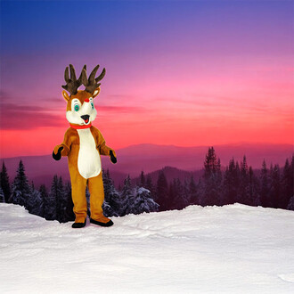 Mascotte de renne de Noël se tenant sur un paysage enneigé, avec un ciel coloré en rose et violet au coucher du soleil, entourée de forêts de conifères.