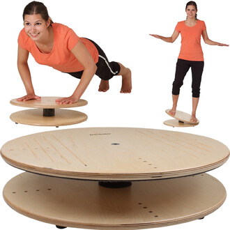 Plateforme de balance Pedalo® Balance Top 500, avec une figure féminine s'exerçant, à mi-chemin entre la position de pompes et celle debout sur la plateforme. La structure en bois circulaire et robuste est visible, avec des rainures et une base stable.