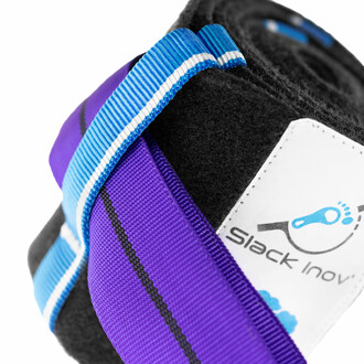 Protection d'arbre XXL SlackInov enroulée, avec une slackline violette soutenue par des sangles bleues et une étiquette blanche affichant le logo Slack Inov, conçue pour protéger les arbres lors de la pratique de la slackline.