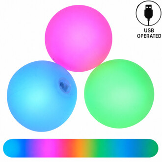 Three Threeworlds LED Lumi Pro luminous silicone juggling balls, one pink, one blue and one green, with a USB symbol indicating that they are USB rechargeable and a color chart at the bottom.