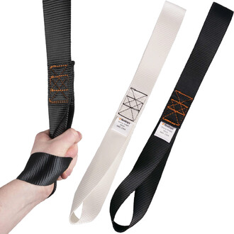 Main tenant un strap de jonglerie Shorty Firetoys, avec deux autres straps de couleur blanche et noire visibles à côté. Les straps sont larges et texturés, montrant des coutures contrastantes.