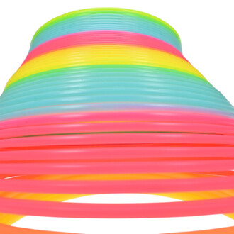 Printemps arc-en-ciel géant avec des bandes de couleurs vives (rose, bleu, jaune, vert) formant un effet de spirale, sur un fond blanc.