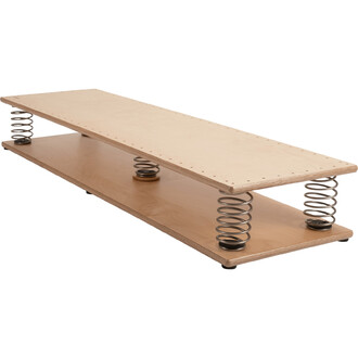 Table de jonglerie en contreplaqué avec des ressorts métalliques sur les côtés, offrant une surface de pratique stable et dynamique. La conception est minimaliste et moderne, avec une finition lisse et naturelle.