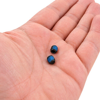 Dois pequenos parafusos pretos sem cabeça com rosca azul, colocados na palma da mão, para fixar as ventoinhas do Halo da Threeworlds.