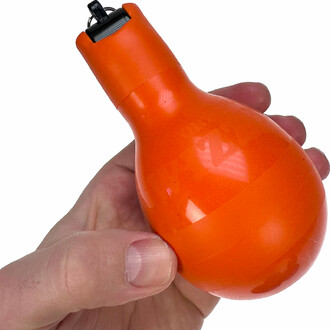 Orange Wizzball whistle held in hand.