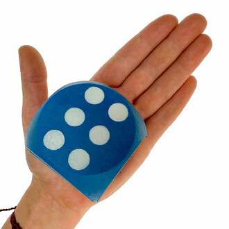 Blue colored dice in a small hand with apple facing up. The die is laid flat with the 6-point side up and visible.