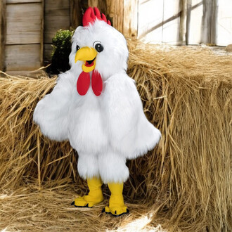 Mascotte représentant une petite poule, vêtue d'une combinaison blanche en fourrure, avec des détails rouges sur la tête et un bec jaune. Elle se tient debout sur un sol en paille, avec des bottes jaunes.