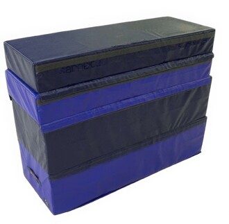 Plinth Modulo 1200, un module de jonglerie composé de plusieurs couches, avec une finition en tissu noir et bleu. Ce produit est conçu pour la pratique sécuritaire et offre un support solide pour les activités de jonglage.